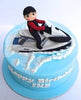 Light blue round fondant cake with 3D jet ski and rider topper and white water splash, Happy Birthday letters