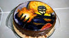 Single-tier round cake with chocolate sides and a full edible image of a comic-style superhero in yellow and black