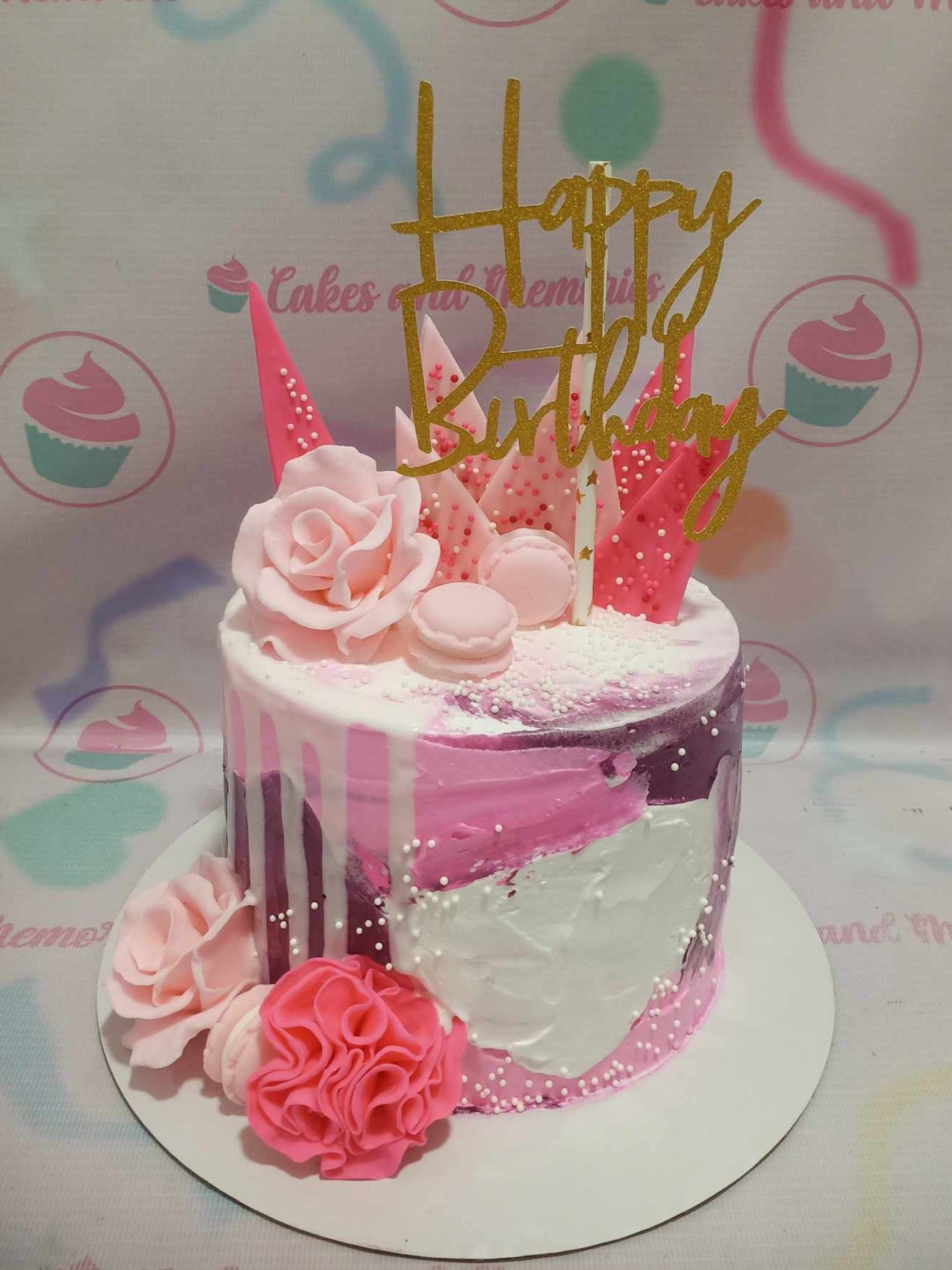 This elegant floral cake features a stunning pink and white drip design, adorned with pink roses and a gold "Happy Birthday" topper. Perfect for a classic 18th birthday celebration, this customized one-layer masterpiece showcases beautiful blooms and sophisticated charm.