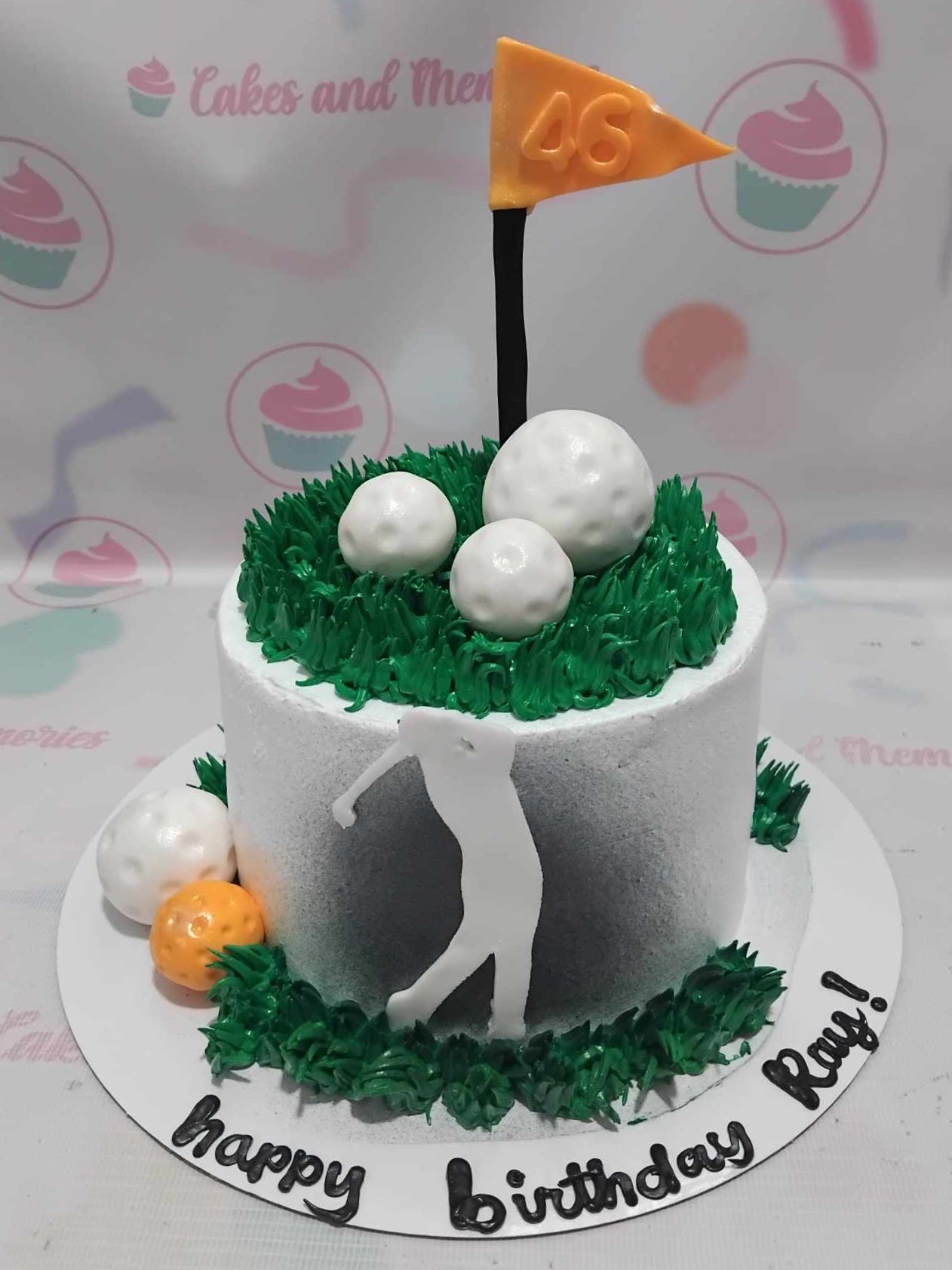 A stunning rectangular Golf Cake featuring lush green grass and white accents, showcasing a golfer silhouette surrounded by golf balls. This customized one-tier creation is perfect for celebrating the special day of a dad, brother, or gentleman who loves the sport.