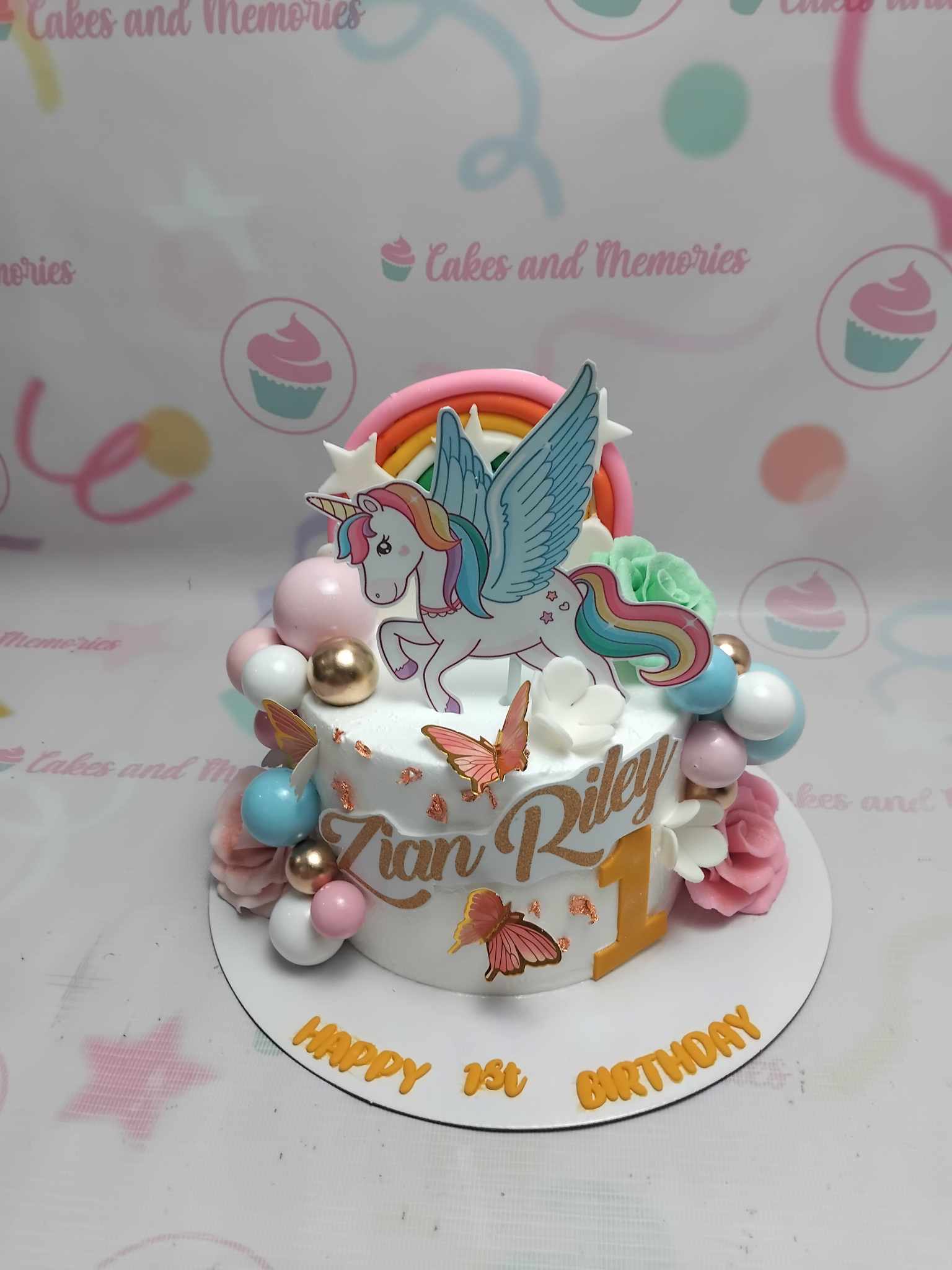 This enchanting Unicorn Cake features a stunning white surface adorned with colorful ball designs and a vibrant rainbow edible topper, perfect for any child's birthday celebration. Customized for a magical experience, this one-tier delight is ideal for girls and kids who adore unicorns.