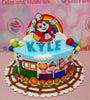 This custom Jolibee Cake features a colorful design with blue, white, red, yellow, and green, showcasing a Jollibee and friends train amidst balloon and cloud accents. Perfect for a baby boy's 1st birthday, the one-tier cake is adorned with playful printout toppers, capturing the joy of the celebration.