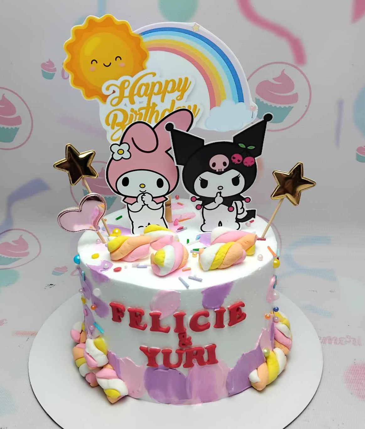 Bright and whimsical, this Kuromi Cake features a delightful blend of white, pink, and purple hues, adorned with charming printout toppers of Hello Kitty and My Melody, set against a sunny rainbow backdrop and playful marshmallows. Perfect for any Sanrio fan, this one-tier creation is sure to bring a smile!