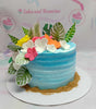 This stunning tropical cake features a blue ombre design, adorned with delightful flowers and leaves, capturing the essence of a beach party. Perfect for summer birthdays, it includes beach sand elements and cheerful printout toppers, showcasing a single tier for a standout celebration.