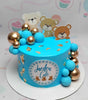 This charming Bears Cake features a delightful blue hue adorned with blue and gold balls, along with elegant golden flakes. Perfect for any celebration, it showcases adorable printout toppers of teddy bears and wild animals, making it a standout personalized birthday treat!