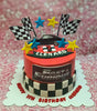 This Fast and Furious Cake features bold red icing and elements of car racing, complete with checkered flags and a Camaro design. Perfectly designed for a 7th birthday celebration, it showcases printout toppers and a dynamic theme.