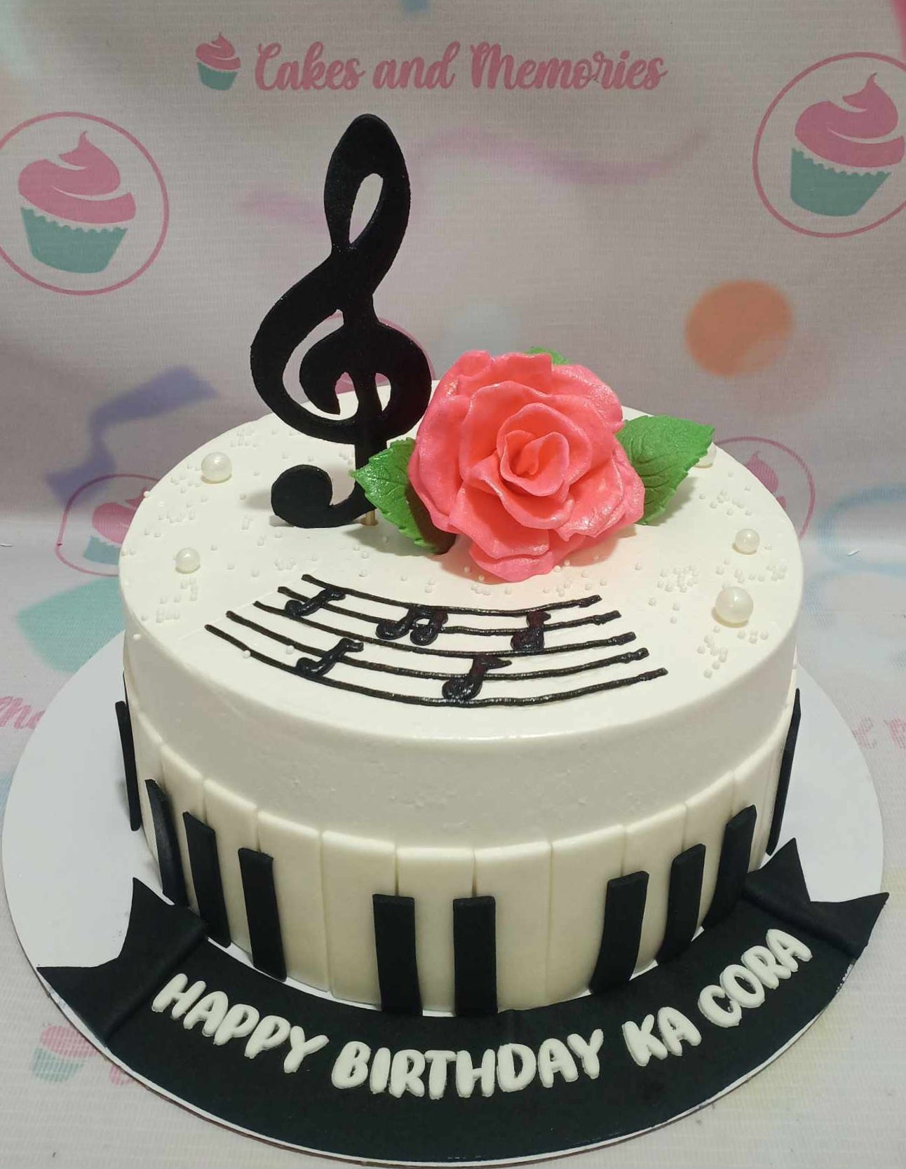 Celebrate your love for music with this stunning 1-tier Music Cake, featuring elegant black and white piano keys, musical notes, and a delicate rose. Perfect for birthdays, this customized cake is ideal for college students, elementary celebrations, or any music enthusiast.