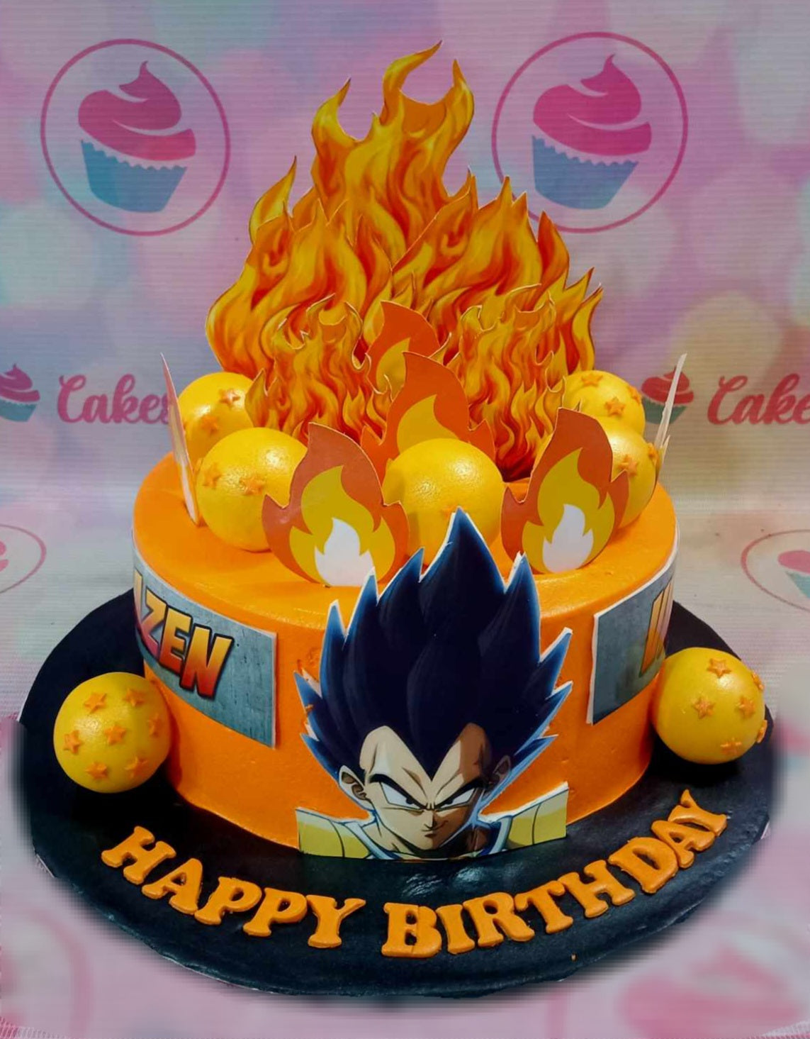 This Dragon Ball Z Cake features a stunning orange and red design with fiery accents, perfect for any anime fan. Adorned with edible dragon ball toppers and characters like Goku, Vegeta, and Gohan, it's a unique birthday cake ready for celebration.