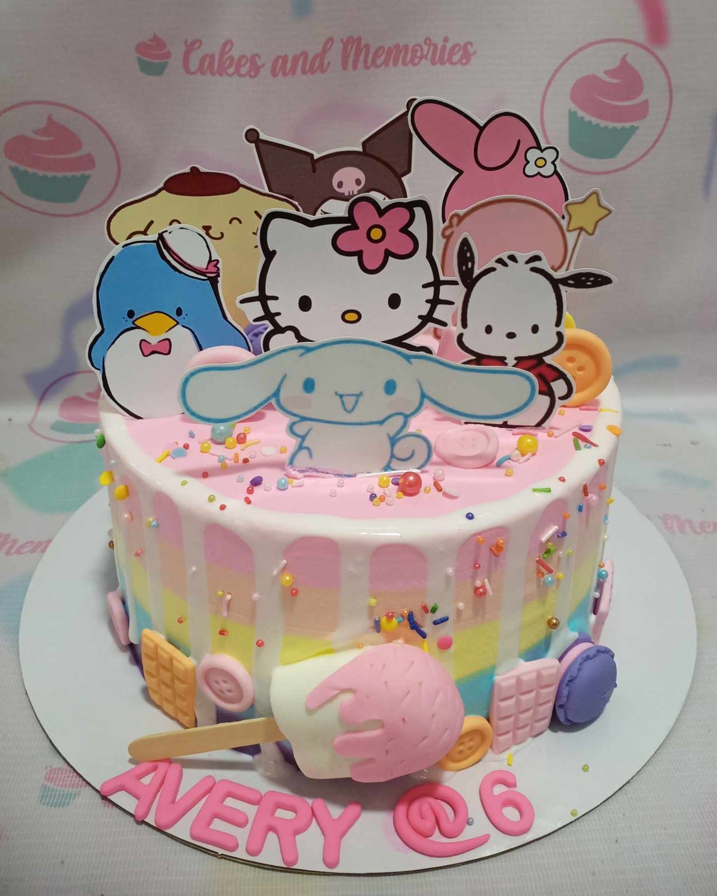 This adorable Hello Kitty Cake features a delightful white drip, vibrant rainbow accents, and playful ice cream popsicles, all topped with charming printout toppers of Hello Kitty and friends like Purin, Cinnamoroll, and more. Perfect for a baby’s birthday celebration, this 1-layer, 1-tier customized cake brings the whimsical world of Sanrio to life.