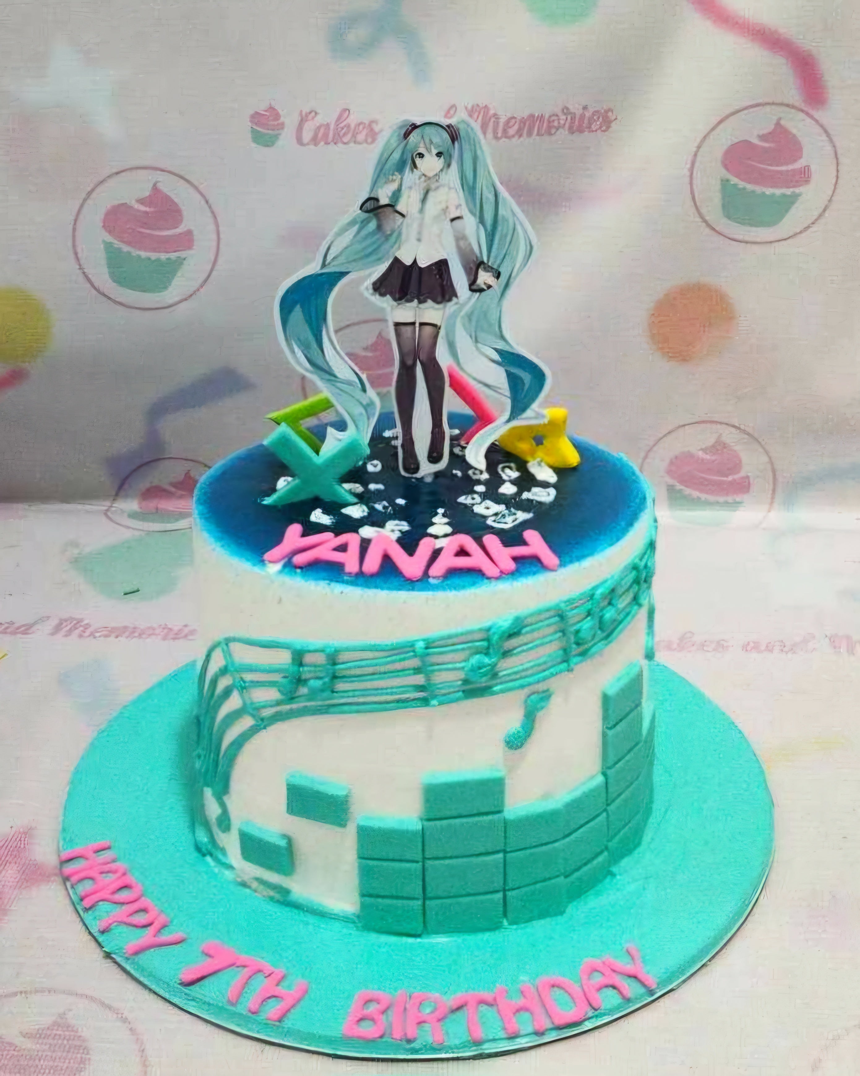 A stunning teal and white anime cake featuring Hatsune Miku from Vocaloid Cv01, adorned with vibrant printout toppers. This one-tier, one-layer masterpiece captures the essence of Japanese culture and animated art, perfect for any fan.