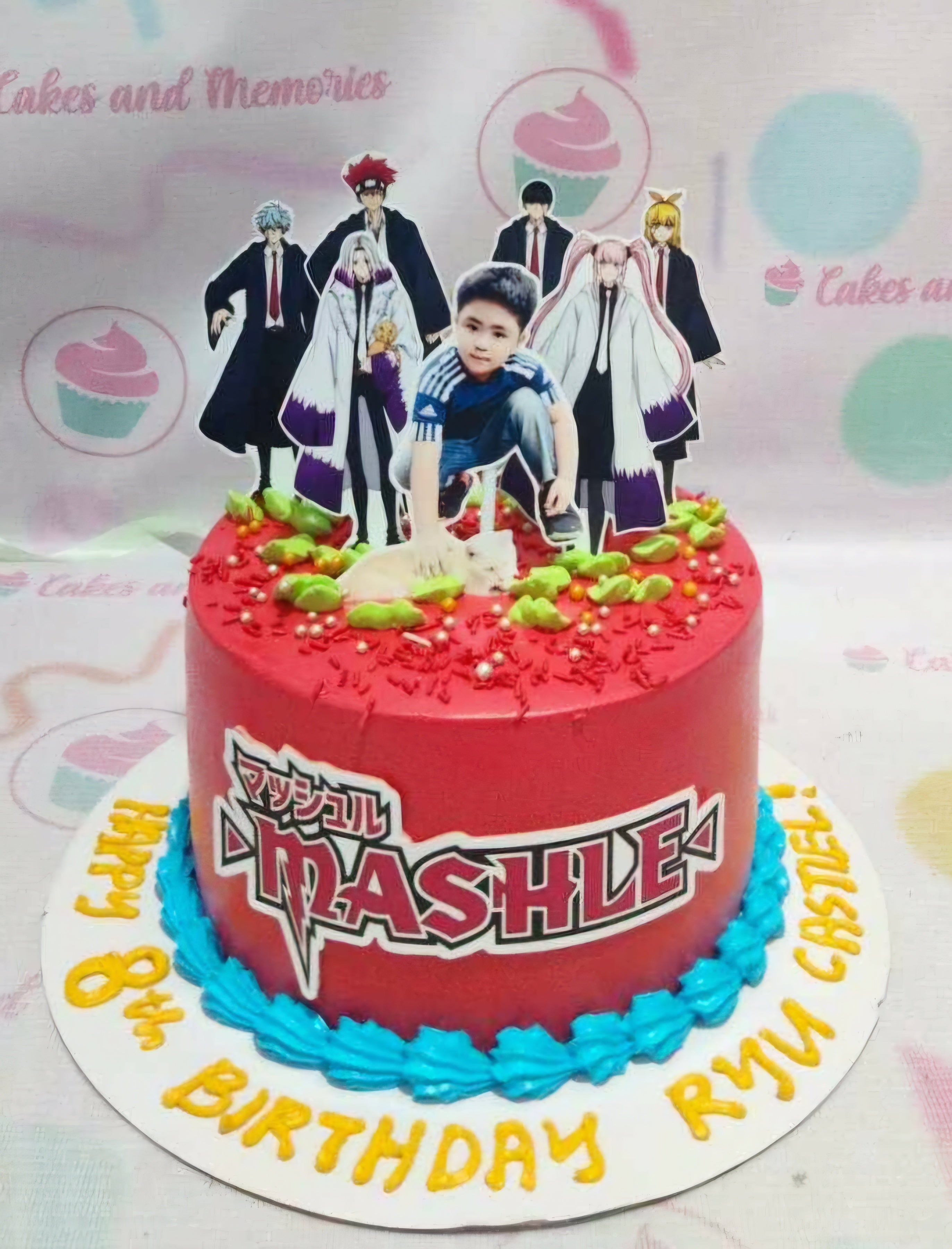 This vibrant red Anime Cake features a single tier adorned with themed printout toppers showcasing characters from "Mashle: Magic and Muscles." Perfectly capturing the spirit of Japanese comics, this eye-catching design celebrates the world of anime and manga.