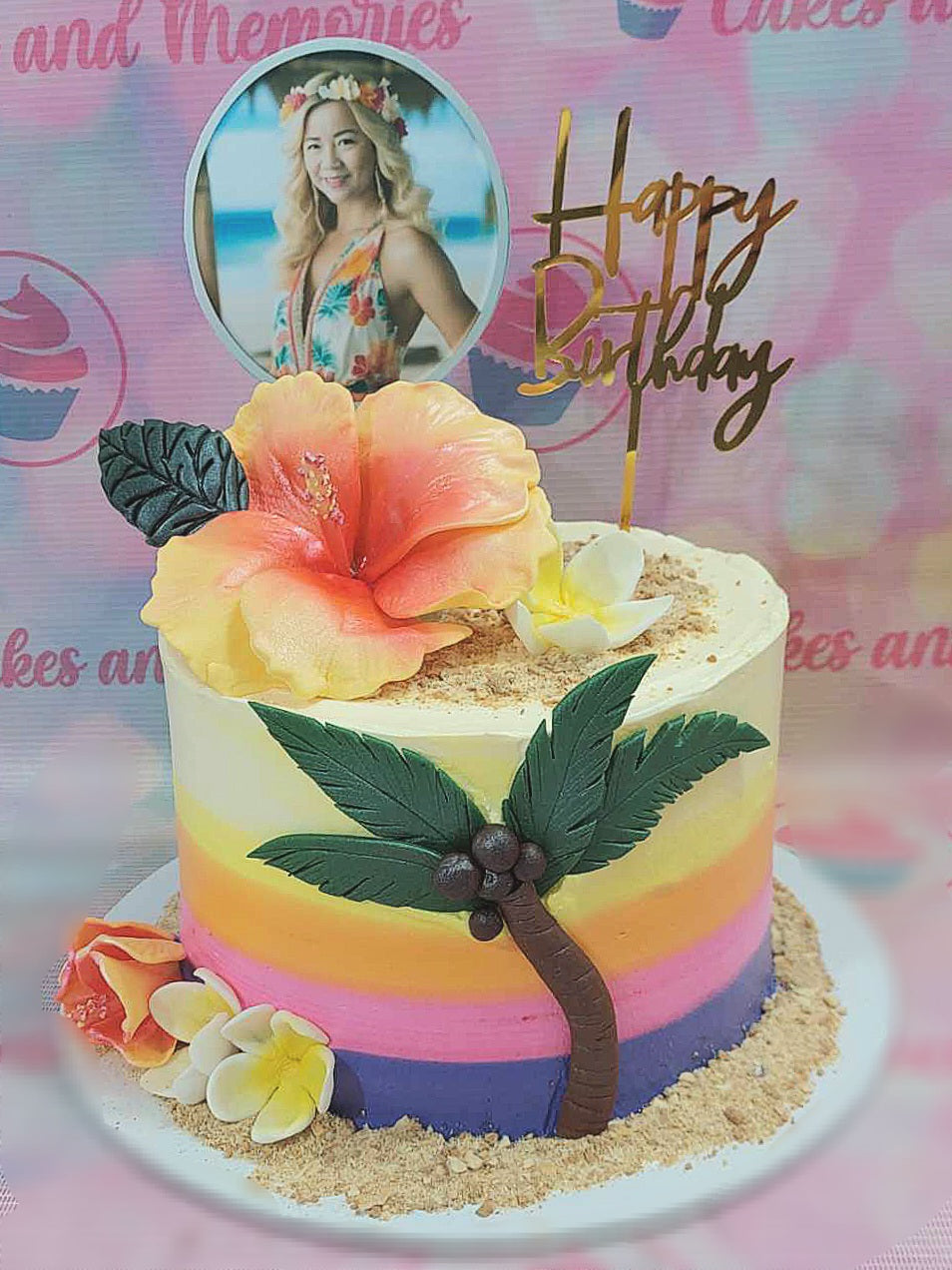 Celebrate with this stunning Tropical Cake featuring a gradient ombre design in pastel yellow, adorned with palm trees, coconut, and vibrant hibiscus flowers. Perfect for a summer birthday, the cake is topped with a stylish "Happy Birthday" gold topper and playful printout toppers, capturing the essence of a beach sunset.