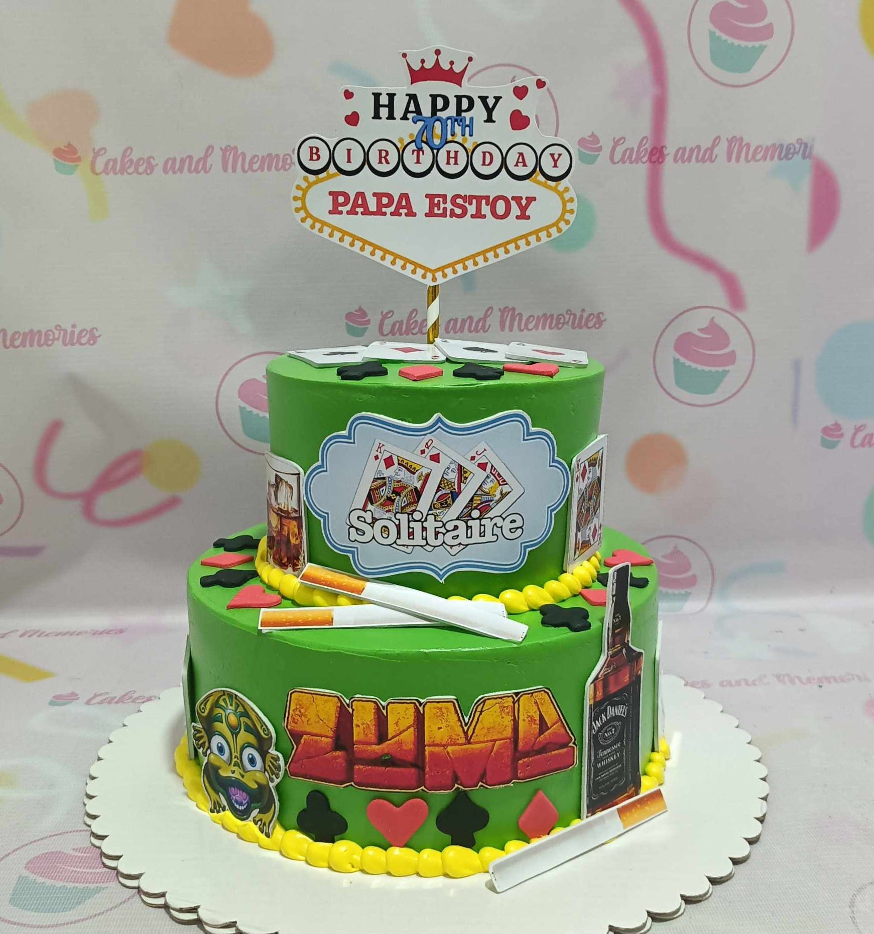 This vibrant green 2-tier Senior Cake features playful playing card toppers inspired by solitaire and online casino themes, perfect for celebrating an 80th, 70th, or 60th birthday. It’s a fun tribute for beloved lola, lolo, daddylo, or mommyla, adorned with Jack Daniel's motifs that capture the spirit of card games.