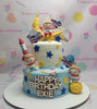 This stunning Space Cake features two layers adorned with blue and white fondant, embellished with yellow stars, planets, and an astronaut. Perfect for Exie's 1st birthday, it showcases a charming spaceship and playful aliens against a celestial backdrop.