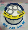 This custom decorated Police Cake features a striking white and blue design, adorned with playful handcuffs and a 