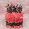 A striking Naruto-themed cake adorned with red and black rosettes, featuring Akatsuki details and printed Naruto character toppers for Yelle's 13th birthday. This one-tier masterpiece captures the essence of anime in its bold design.