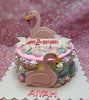 A stunning pink Flamingo Cake designed for Aiyah's 2nd birthday, featuring adorable flamingos, delicate meringue, colorful sprinkles, and elegant flowers adorned with pearls. This one-tier masterpiece captures a pastel rainbow theme that perfectly complements the celebration.