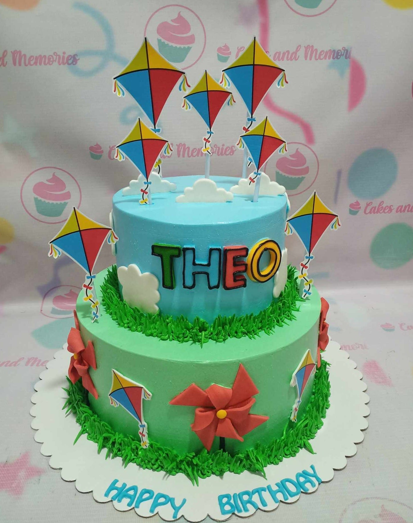 Celebrate in style with our Flying Kites Cake, featuring vibrant blue and green colors along with delightful kite and pinwheel printout toppers. This charming 2-tiered design captures the essence of a windy day, perfect for any occasion!