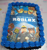 A custom rectangular Roblox cake features a vivid blue design adorned with edible images of popular Roblox characters and playful star accents, perfect for a kids' birthday party. This cake is a must-have for any young gamer looking to celebrate their love for the video game.