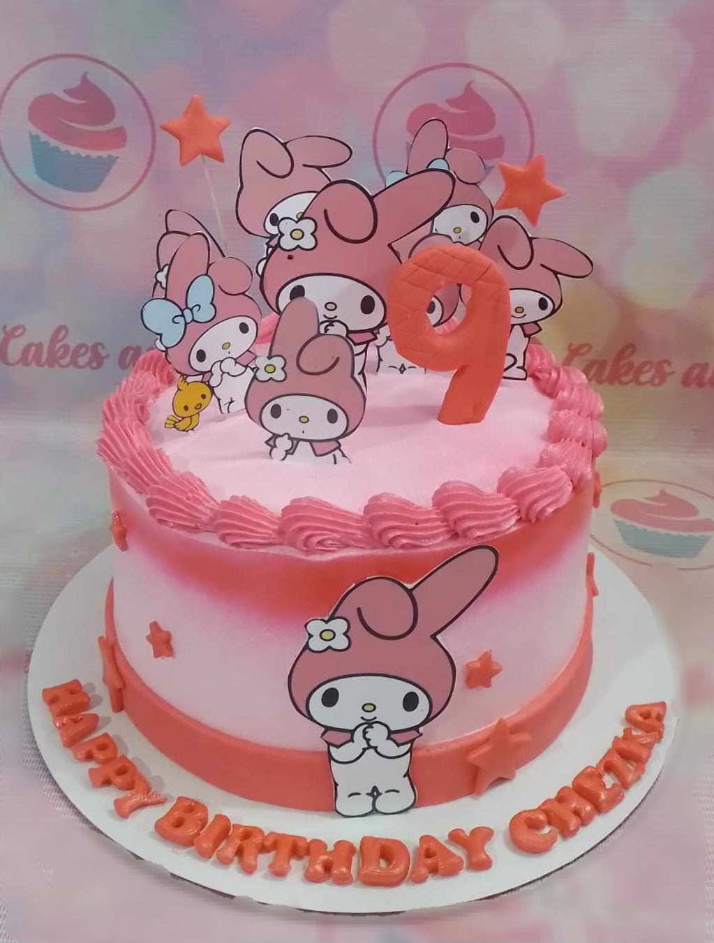 This whimsical My Melody Cake features a delightful layer of frosted pink icing, adorned with charming printout toppers and a playful number nine. Perfect for a 9th birthday celebration, it showcases cute Sanrio characters that bring joy to any party.