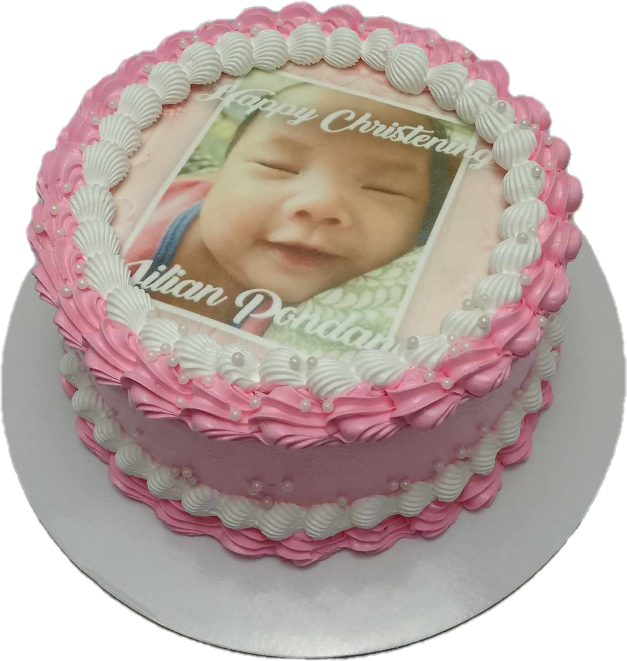 This charming Christening Girl Cake features soft pink and white colors, adorned with an edible photo of the baby girl, perfect for a happy christening or baptismal celebration. It includes a single tier design, making it a delightful centerpiece for the special occasion.