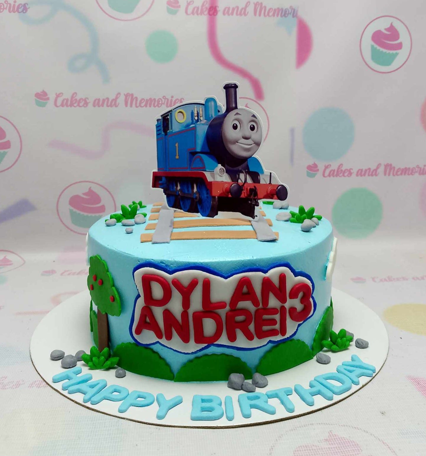 This vibrant blue Bus Train Trucks Cake features adorable Thomas the Train printout toppers, perfect for celebrating your baby's 1st or 2nd birthday. Designed in a single tier, this customized cake is a delightful centerpiece for any toddler's birthday party.