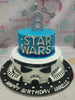 This stunning 2-tier Star Wars cake features a vibrant blue and white design, perfect for an 8th birthday celebration, complete with a detailed Stormtrooper helmet and Jedi accents. Custom decorated to truly embody the excitement of the galaxy far, far away, it’s a memorable centerpiece for any birthday party.