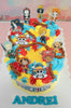 This custom One Piece cake features a rectangular design adorned with colorful printout toppers of Luffy, Zoro, Sanji, Chopper, and Nami, set against a backdrop of yellow, blue, and red. The cake showcases a playful skull and crossbones theme, complete with rope, stars, and pearls, perfect for Andrei's 6th birthday celebration.