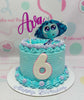 This vibrant Inside Out Cake features a stunning teal and blue design with a purple border, perfect for a 6th birthday celebration. Adorned with a glitter topper and colorful printout toppers of emotions from the Pixar animated film, it encapsulates joy, sadness, anger, and disgust in a delightful 1-tier presentation.