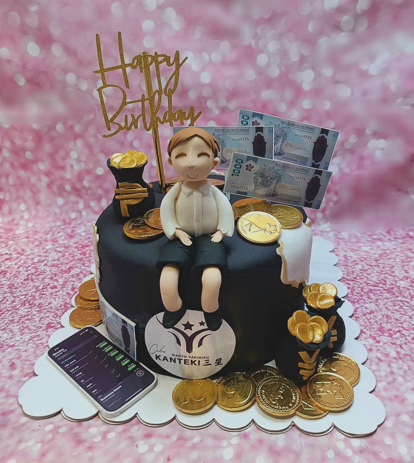 This custom business-themed cake features sleek black fondant adorned with gold coins, cash, and printout toppers representing crypto and forex trading. Topped with a golden "Happy Birthday" topper, it’s a perfect choice for a finance professional celebrating a special occasion.