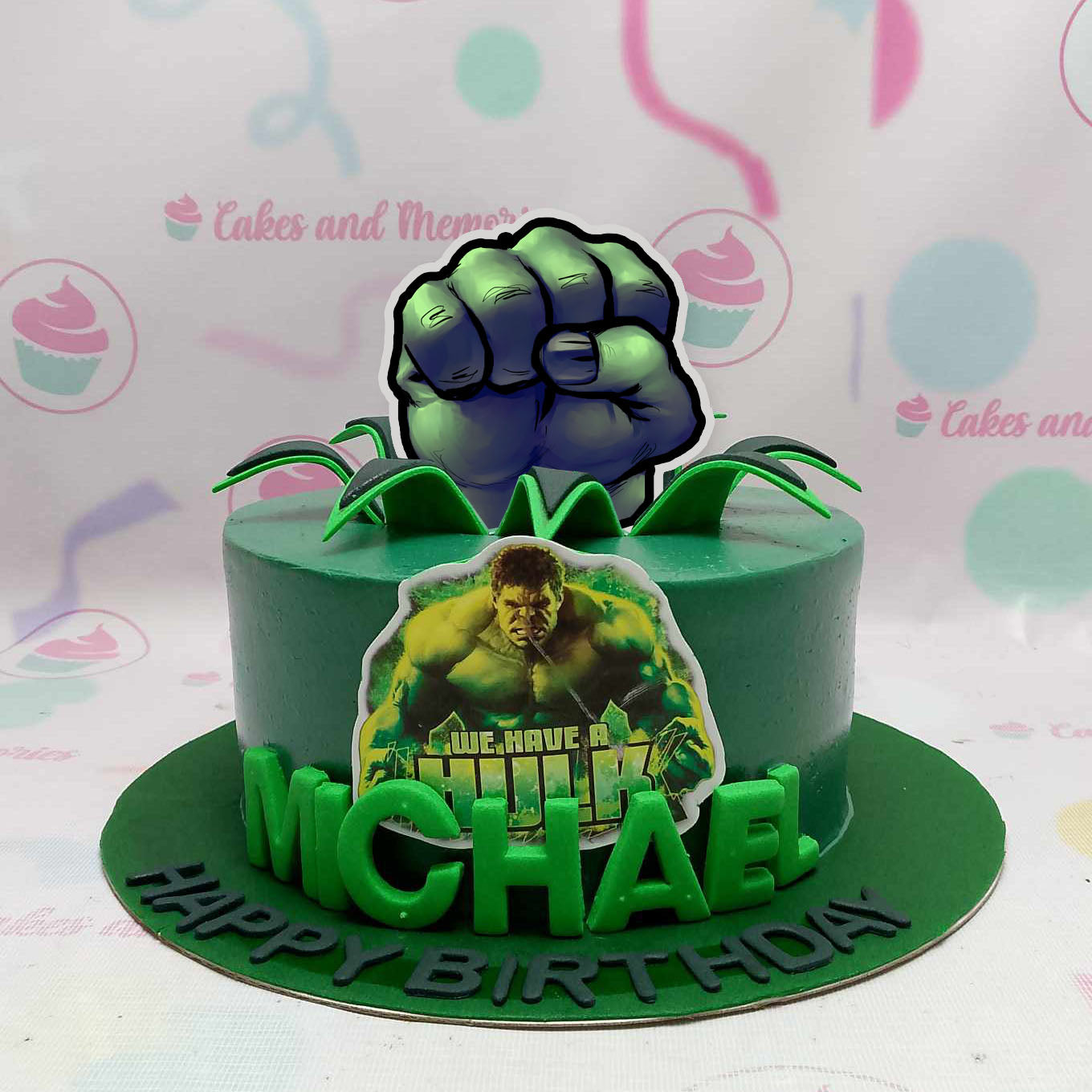 Introducing our vibrant Hulk Cake, featuring a striking green design and an impressive printout topper of the iconic Hulk fist ready to 'smash' any celebration. Perfect for Marvel and MCU fans, this single-tier cake adds a heroic touch to any event!