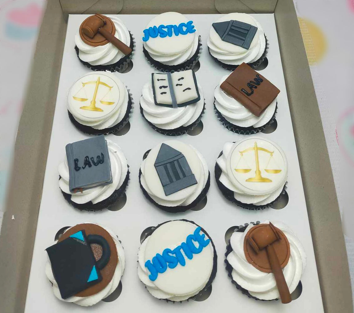 This custom cake features elegant lawyer-themed cupcakes adorned with edible toppers, including scales of justice, a gavel, and law books, all set against a sophisticated palette of white, blue, brown, gray, and gold. Ideal for celebrating graduation or passing the bar exam, it captures the essence of the legal profession in a creative design.