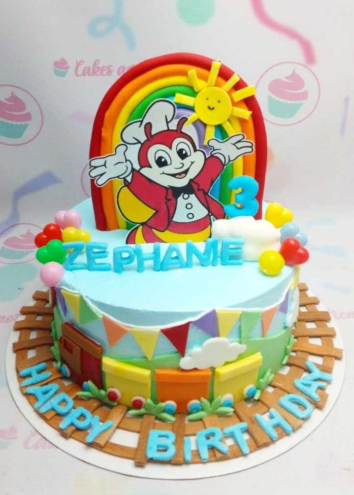 Celebrate your special day with this vibrant Jolibee Cake, featuring a playful design with blue banderitas, a charming train, and colorful balloons. Topped with an edible rainbow, this 1-tier masterpiece brings a sunny touch to your birthday celebrations!