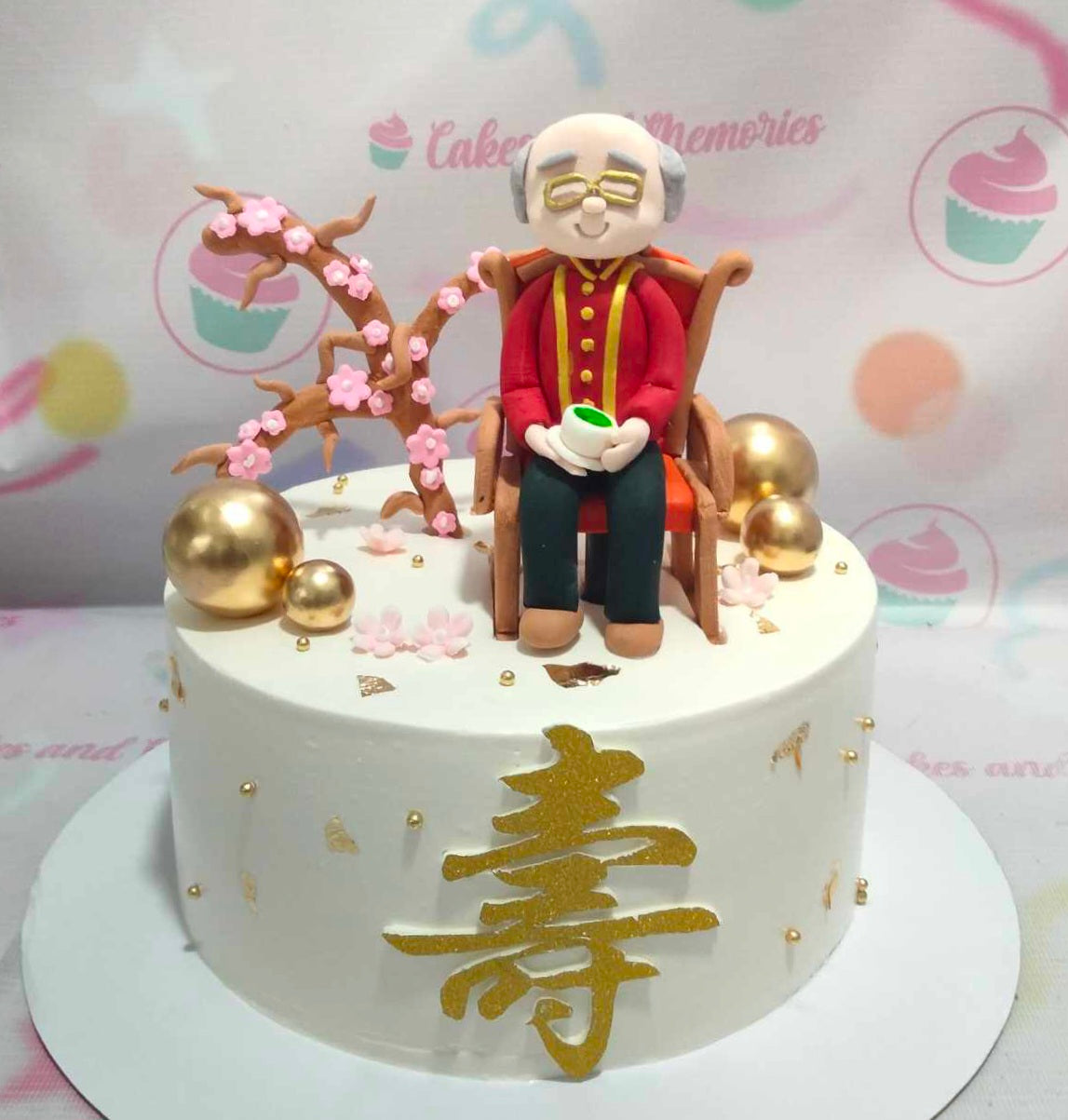 Celebrate a milestone with this elegant Senior Cake, featuring a pristine white exterior adorned with delicate cherry blossoms and shimmering gold balls. Perfect for honoring longevity, this stunning 1-tier design is ideal for 60th, 70th, or 80th birthday celebrations for beloved grandparents.