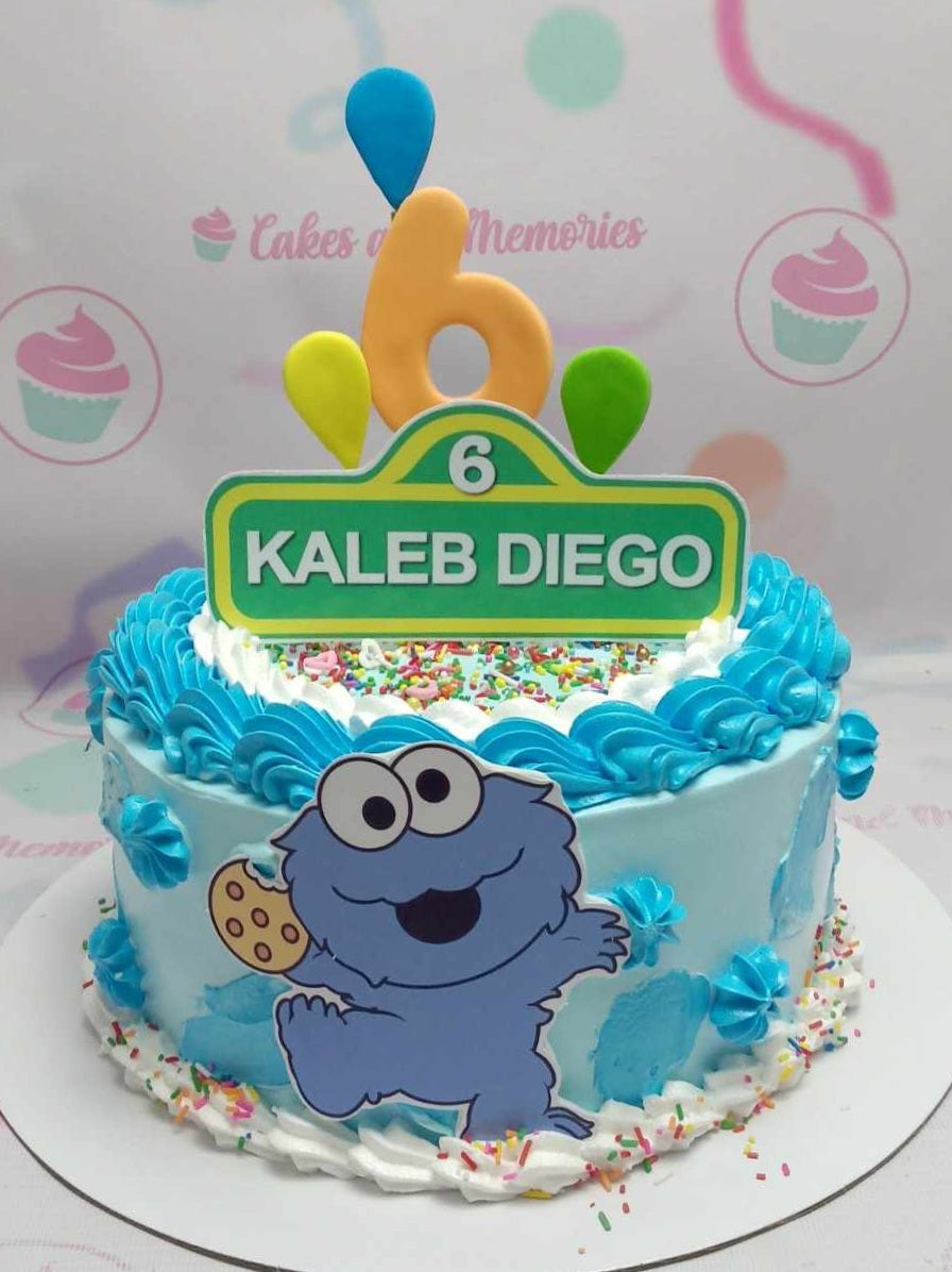 This charming Sesame Street cake features a lively blue design adorned with candy sprinkles, a delightful baby Cookie Monster, and colorful printout toppers of Bert, Big Bird, and Elmo. Ideal for a child's birthday celebration, this one-tier cake is a whimsical tribute to their favorite kids' TV show.