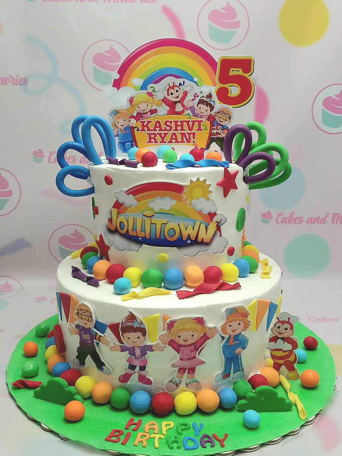 Capture the joy of a 5th birthday celebration with this custom Jolibee Cake featuring Jollibee and friends, adorned with a rainbow printout and playful printout toppers. The two-tiered design showcases colorful balls, flags, and beloved characters like Hetty Spaghetti, Yum Burger, Twirlie, and Popo Fries, creating a festive centerpiece for any party.