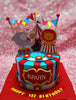 This colorful Carnival Cake features blue icing adorned with red stripes, showcasing a delightful circus theme complete with an elephant, lion, and a tent topped with flags and stars. Perfect for a 1st birthday celebration, it includes charming printout toppers on a single tier design.