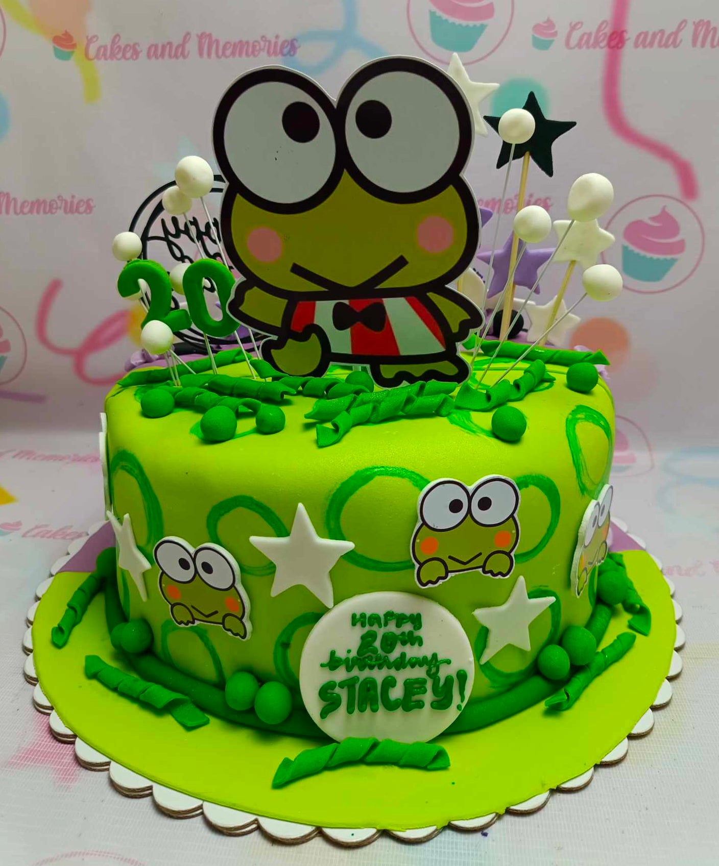 A delightful Keroppi Cake featuring vibrant green fondant and playful frog designs, perfect for fans of Sanrio's Hello Kitty and friends. This charming one-tier cake is adorned with cute printout toppers and brings a whimsical touch to any celebration.