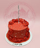 1-tier red birthday cake with red buttercream rosettes, white pearl sprinkles, a silver spiral candle, and 