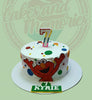 Round Elmo 7th birthday cake with colorful polka dots, a number 7 candle, and 'KYRIE' plaque on white icing.