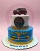 2-tier birthday cake with red Land Cruiser, Rolex watch, '70 Years of Timeless Journeys' in blue, white, and gold.