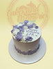 One-tier buttercream birthday cake with purple and white rosettes, textured sides, and 'Happy Birthday LPR' text.