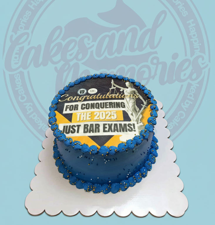 One-tier congratulations cake with Lady Justice edible print for passing bar exams, dark blue buttercream, gold sprinkles.