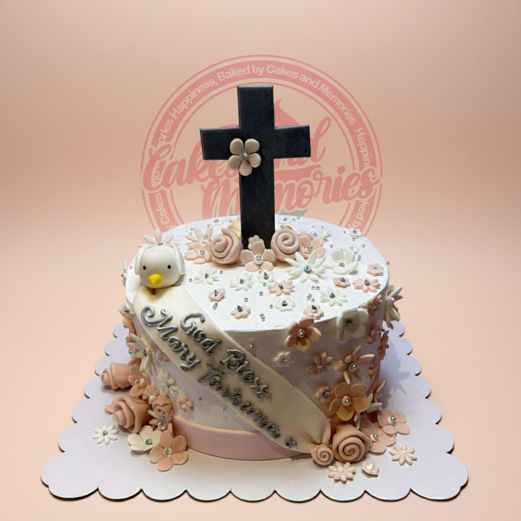 One-tier christening cake with white and peach fondant flowers, a black cross topper, dove, and 'God Bless Mary Farhana' banner.