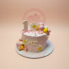 One-tier first birthday cake for Chelsey Isabelle with pink buttercream, daisy flowers, pink/yellow/white spheres, and '1' topper.