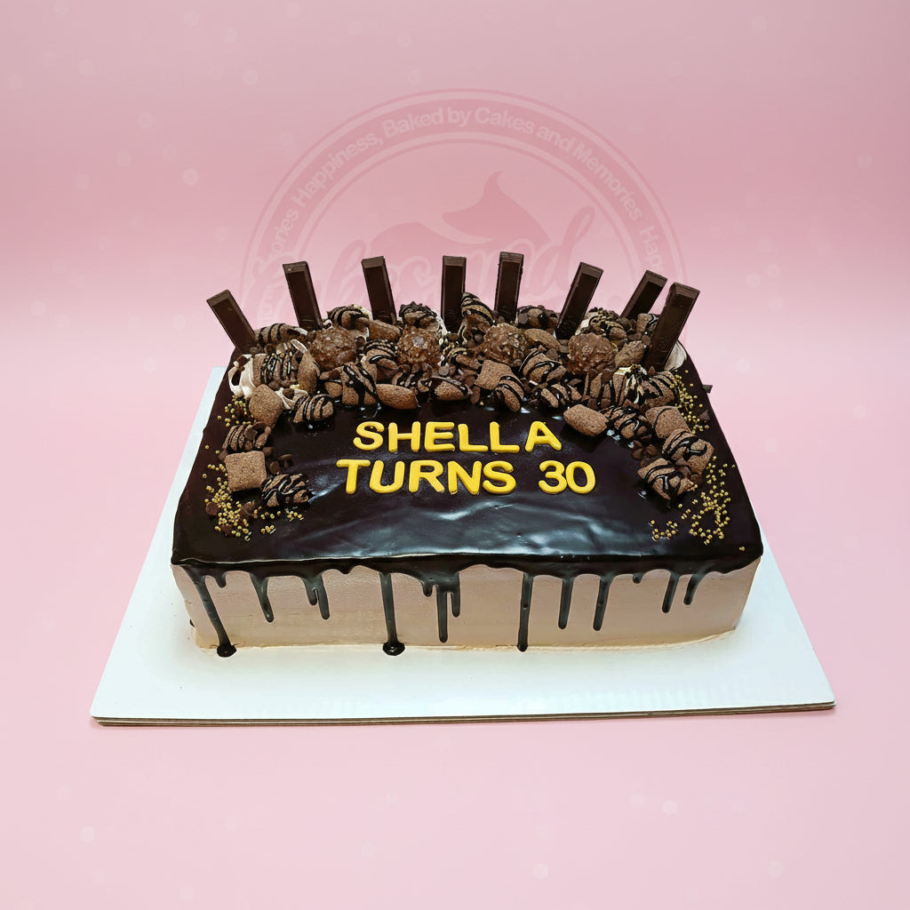Rectangular chocolate drip birthday cake for Shella's 30th, topped with chocolates, bars, and gold sprinkles.
