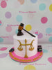 One-tier lawyer-themed birthday cake with gold scales of justice, black gavel, law books, and 