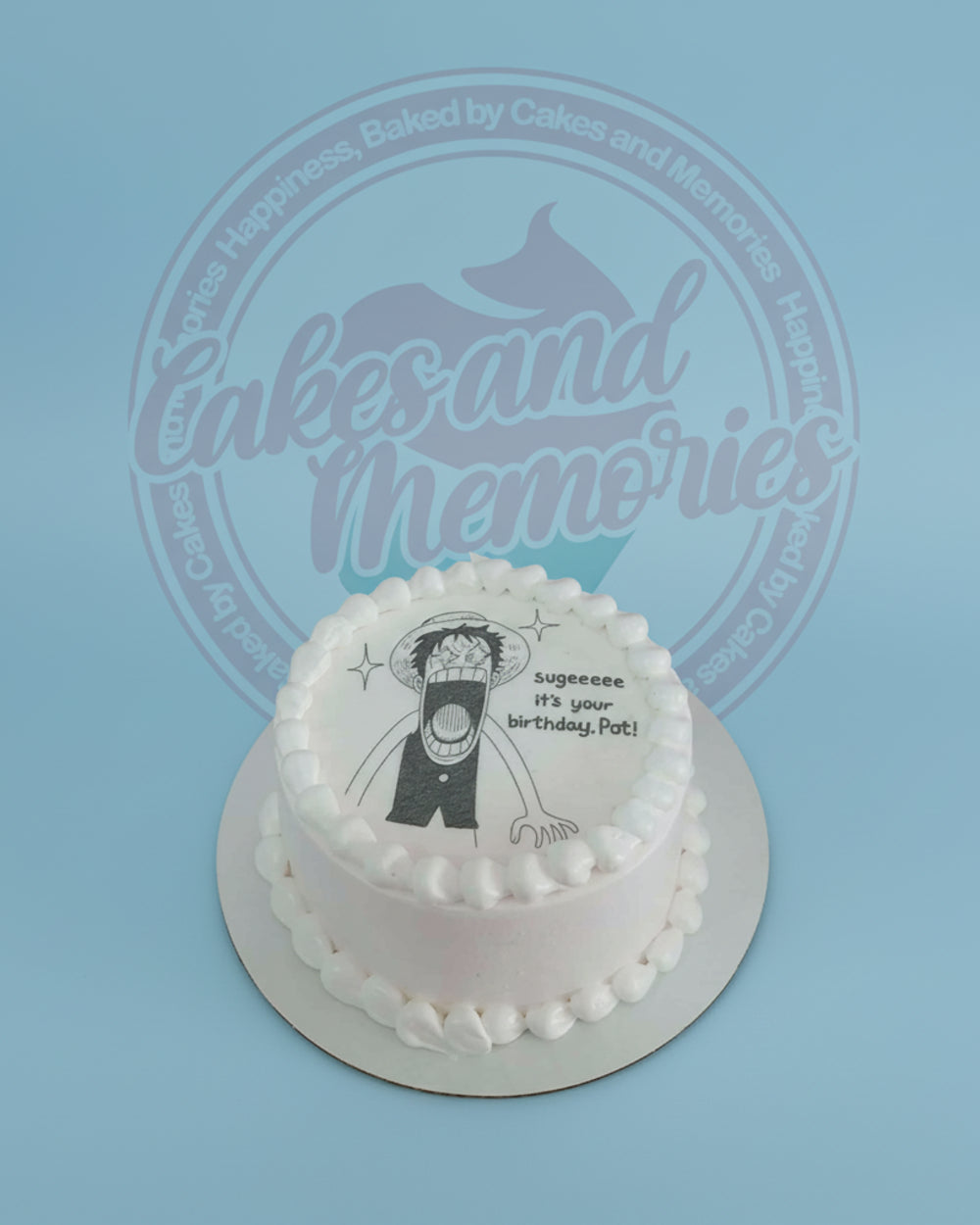 One-tier round birthday cake with white buttercream and an edible print of One Piece's Luffy saying 'Sugeeeee it's your birthday, Pat!'