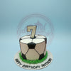 One-tier soccer ball birthday cake with black and white panels, green grass border, and a '7' topper for Anthony.