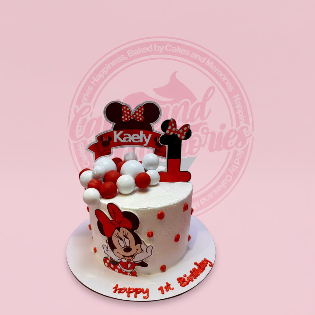 One-tier Minnie Mouse 1st birthday cake for Kaely, with edible print, custom topper, and red & white spheres.
